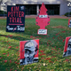 Posters stand on the south lawn Tuesday, Nov. 30, 2021, at the Hennepin County Government Center in Minneapolis where jury selection begins for former suburban Minneapolis police officer Kim Potter, who says she meant to grab her Taser instead of her handgun when she shot and killed motorist Daunte Wright.